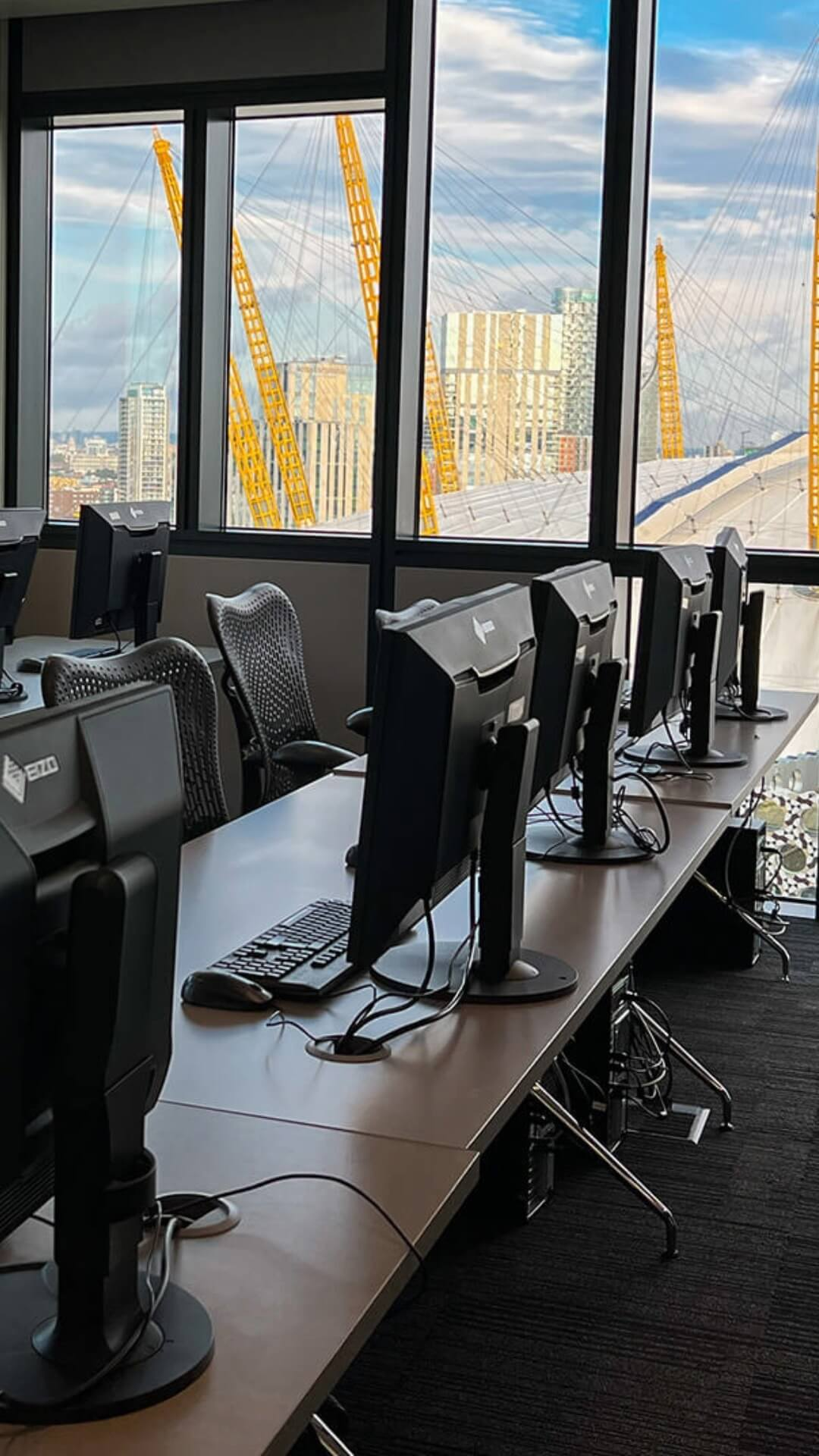 Classroom with workstations and windows overlooking the O2.