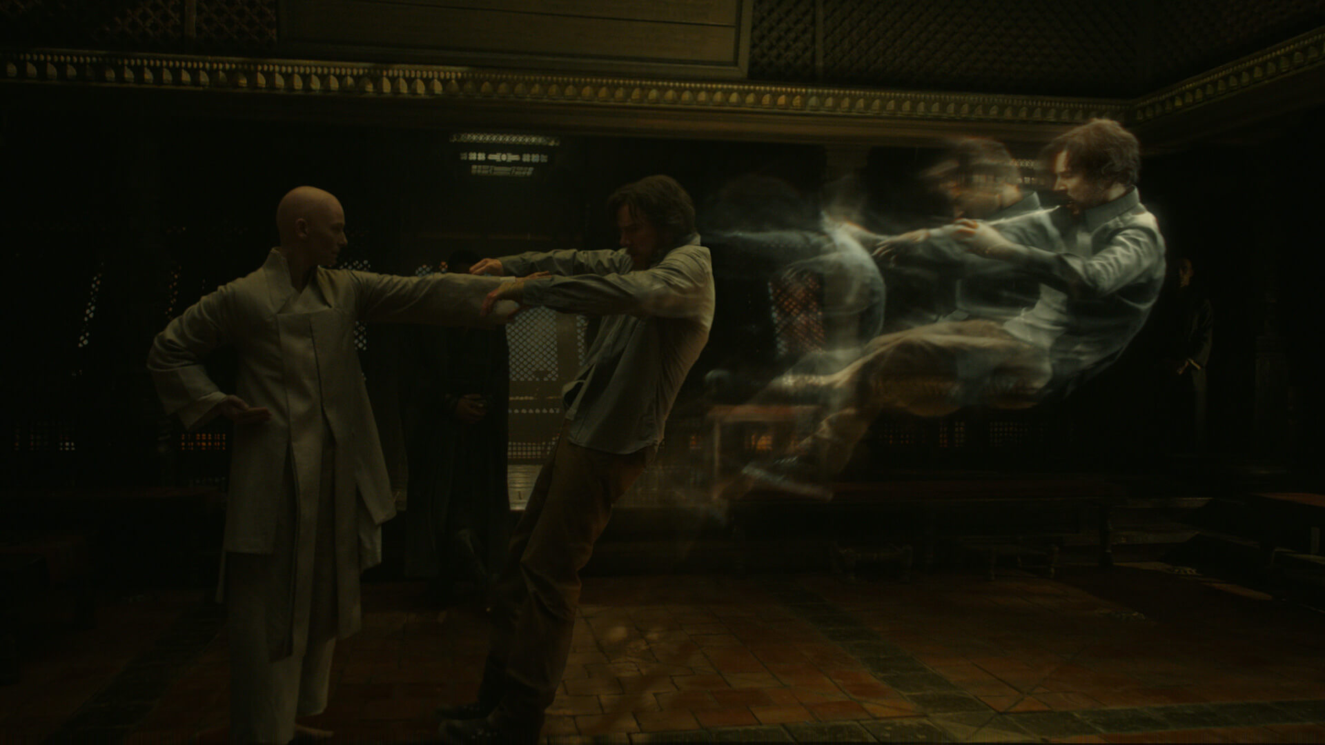 A monk punching a man with him flying backwards in stages