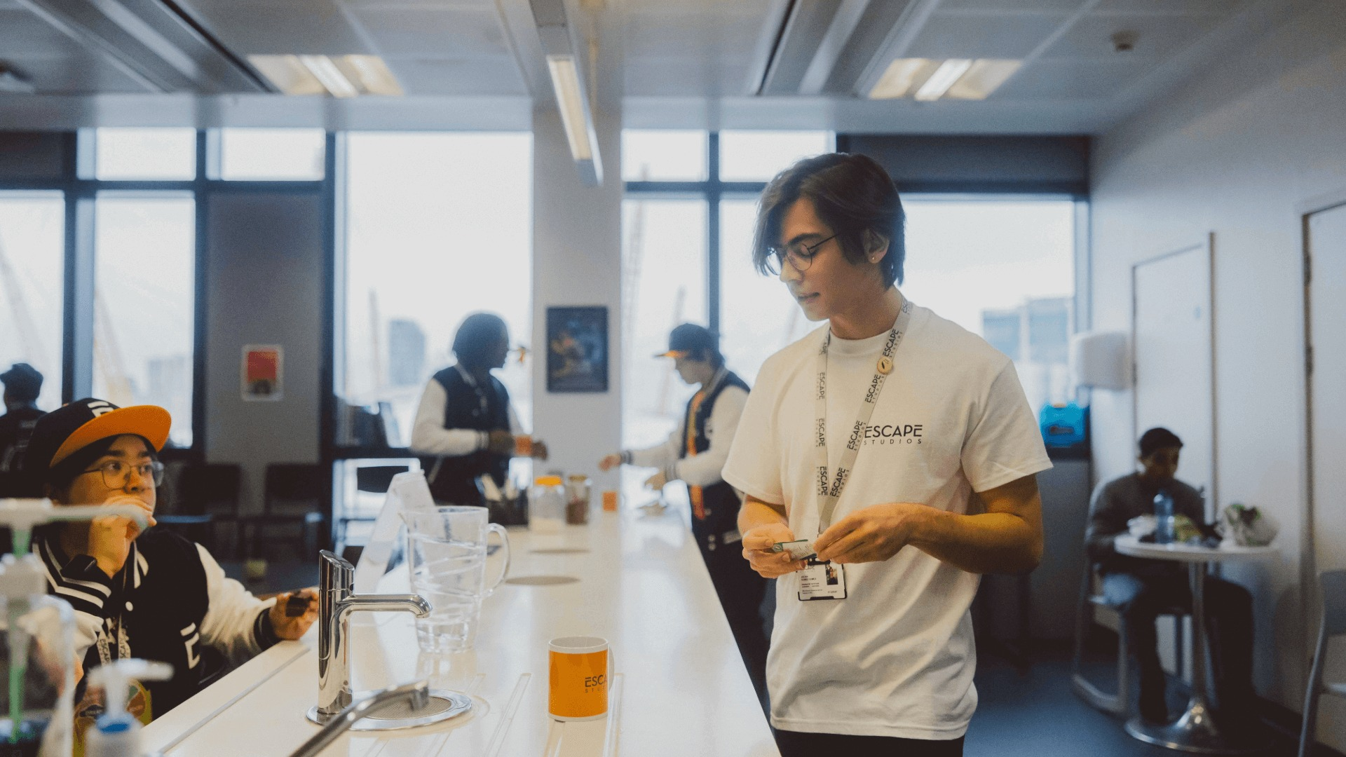 A kitchen with students using the facilities to make drinks