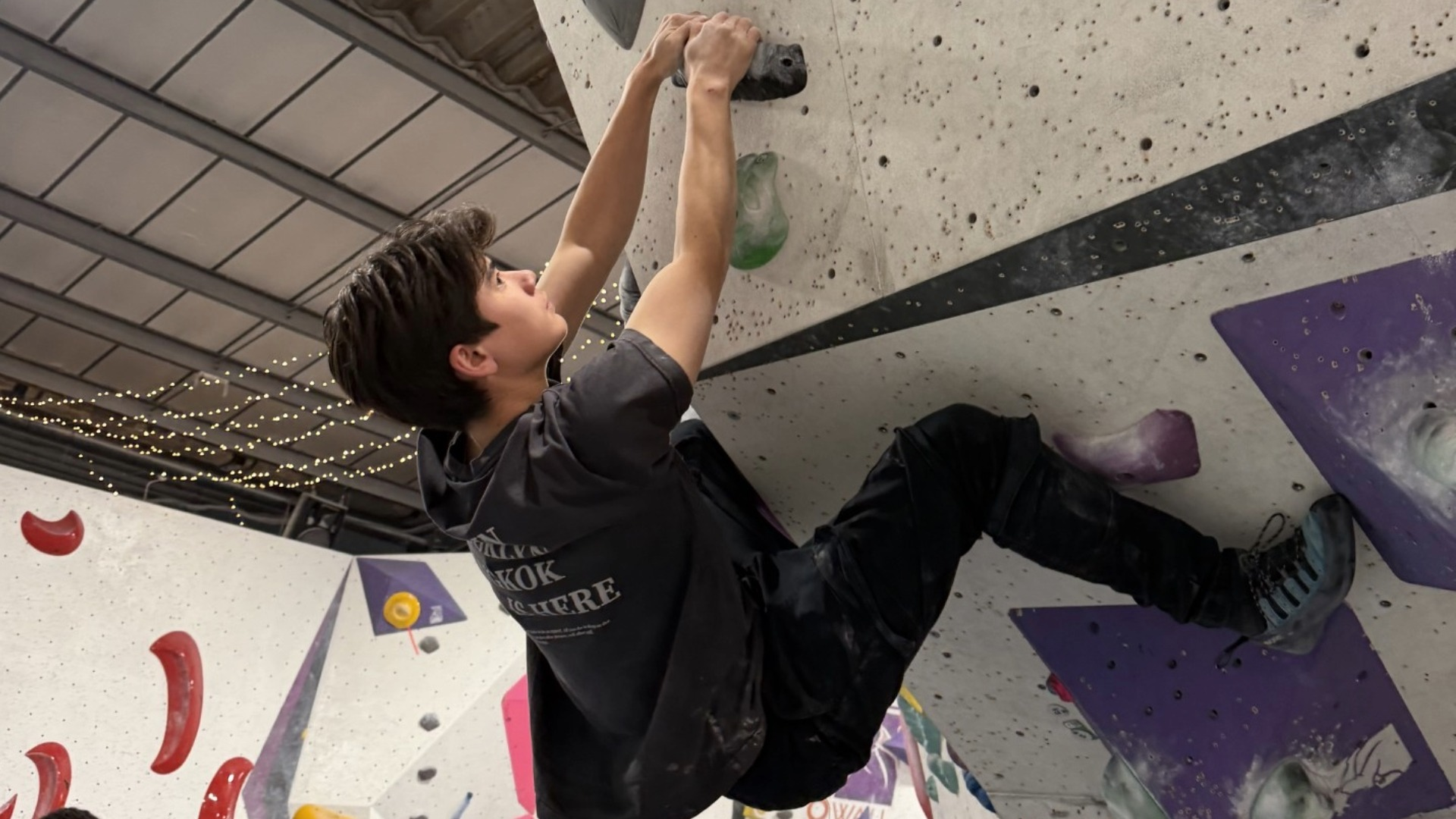 student rock climbing
