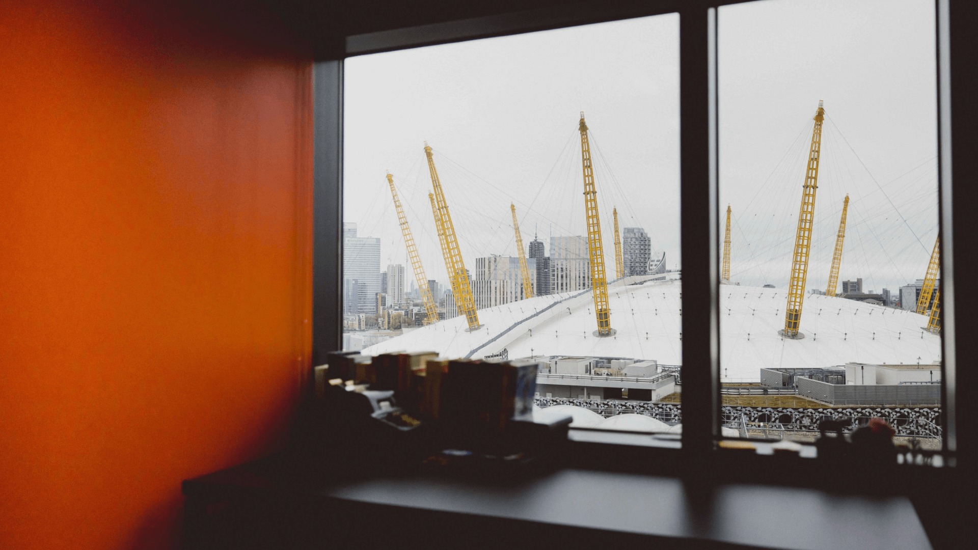 A view of the O2 and Canary Wharf in the background from a window