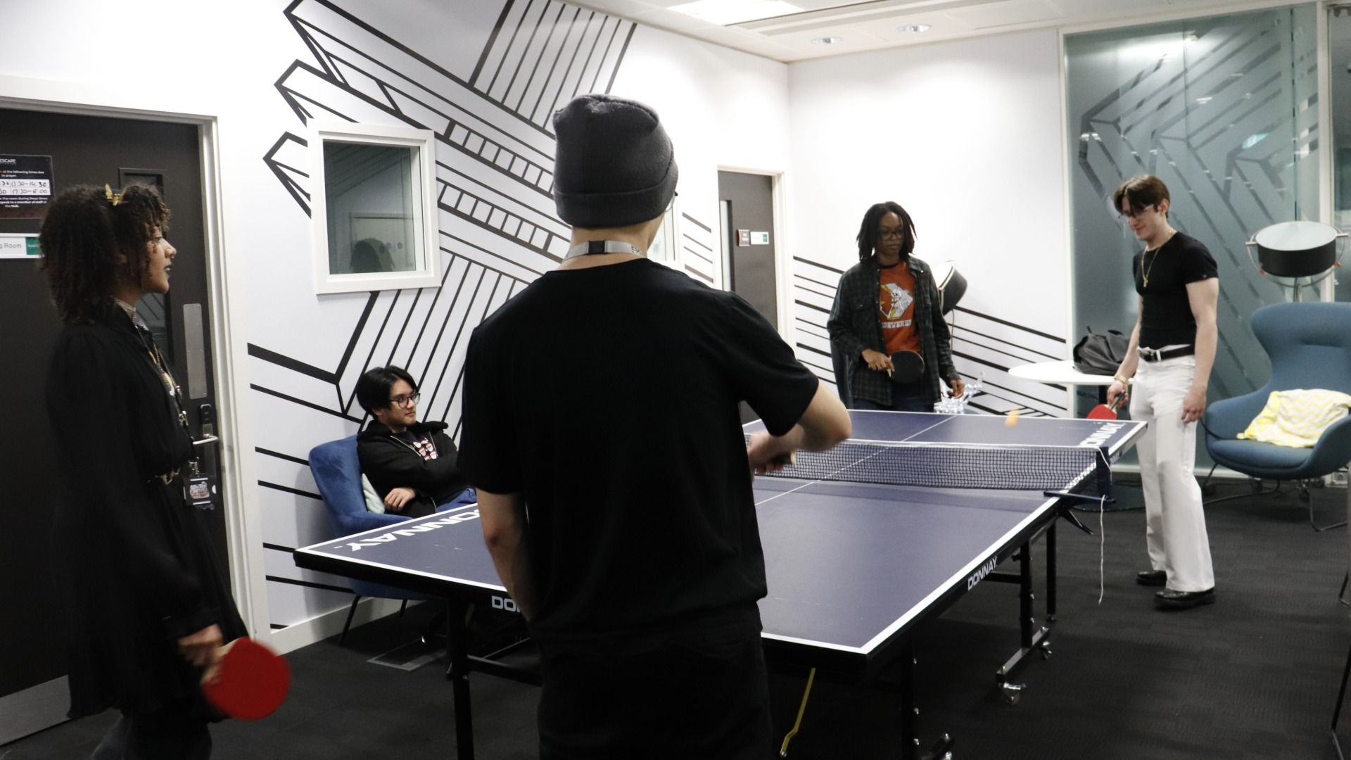 students playing ping pong at the 2025 christmas party