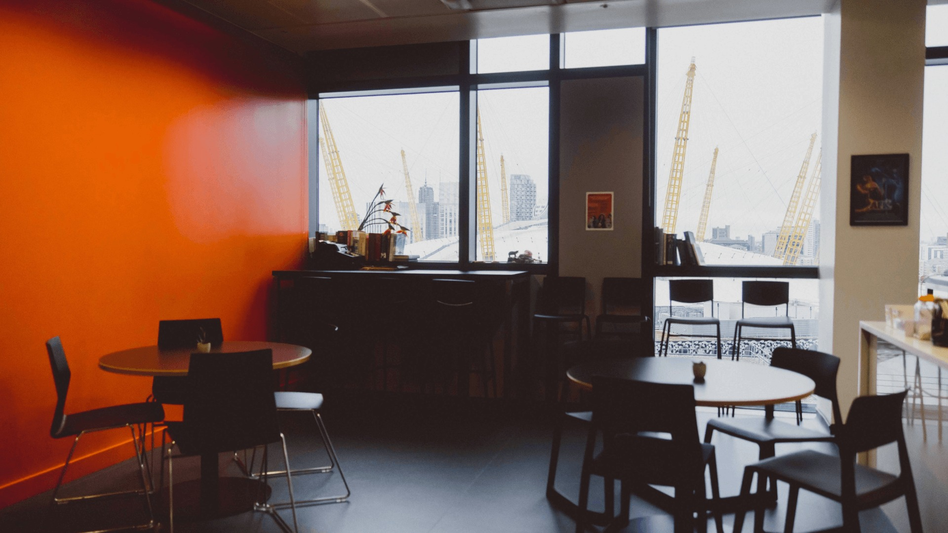 Kitchen area with tables and chairs and a view of the O2 out the window